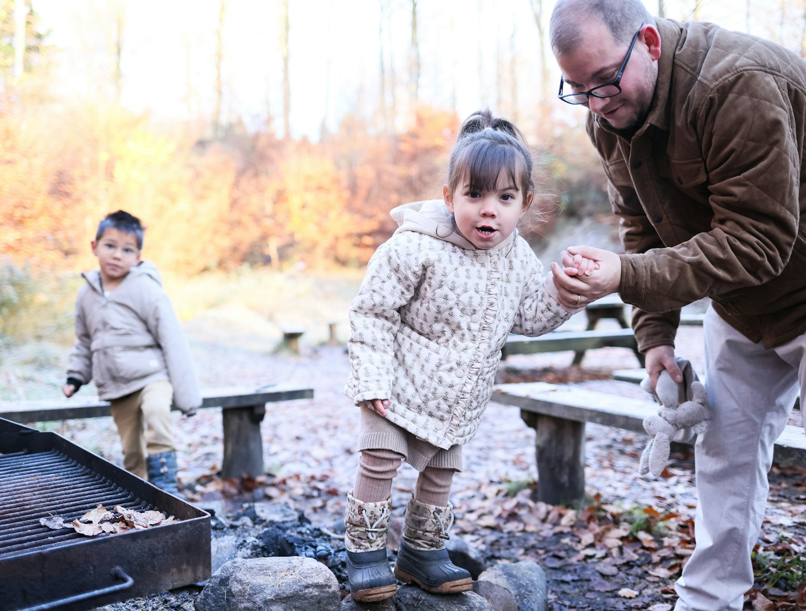 Grandfather walking with his grandchildren outdoors