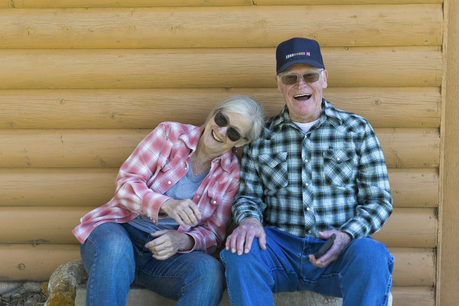 Happy older couple sitting together outdoors
